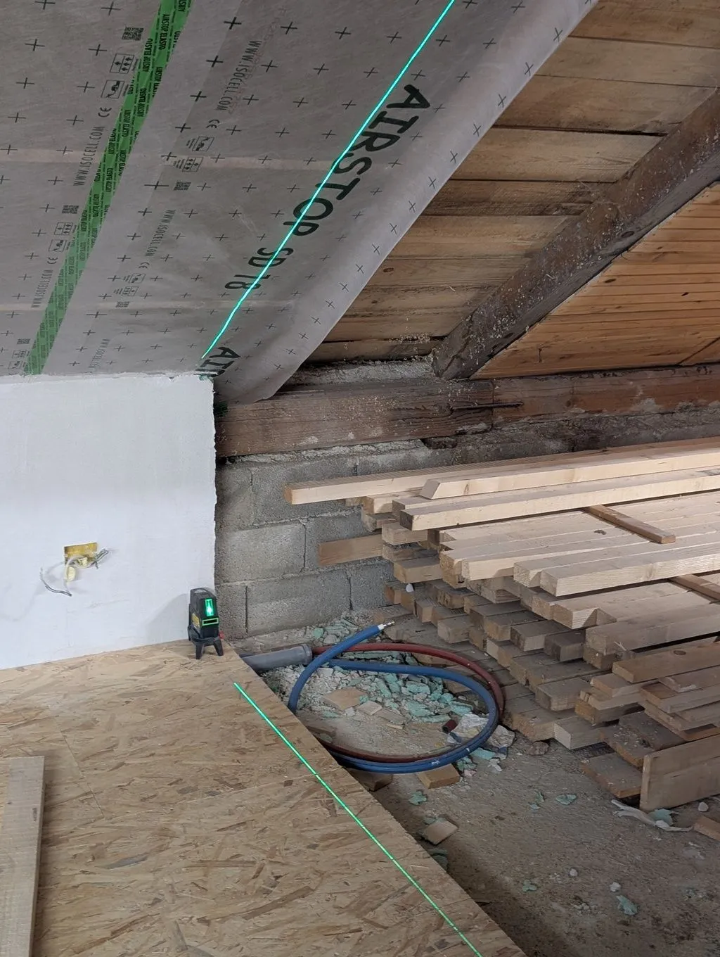 Using a laser level to lay out the position of the top and bottom plates.