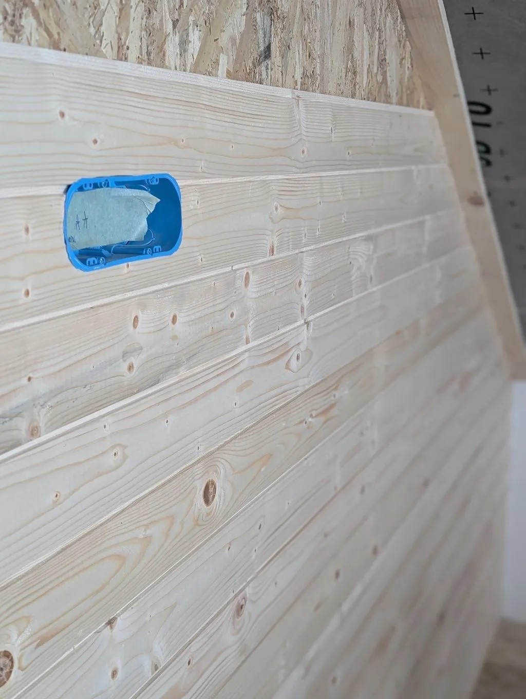 The first boards going up on the main partition wall. The natural wood grain makes for a warm, cozy interior.
