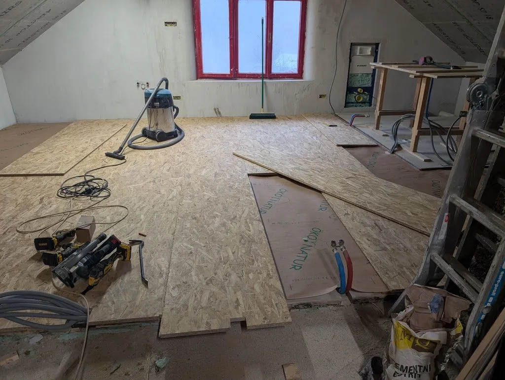 The installation of the OSB subfloor in progress.