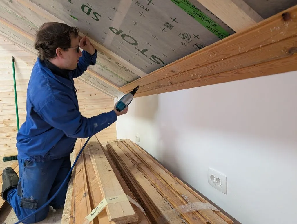 Martin helped throughout the ceiling finish process. Here he is attaching the first few boards with an 18 gauge pneumatic brad nailer.