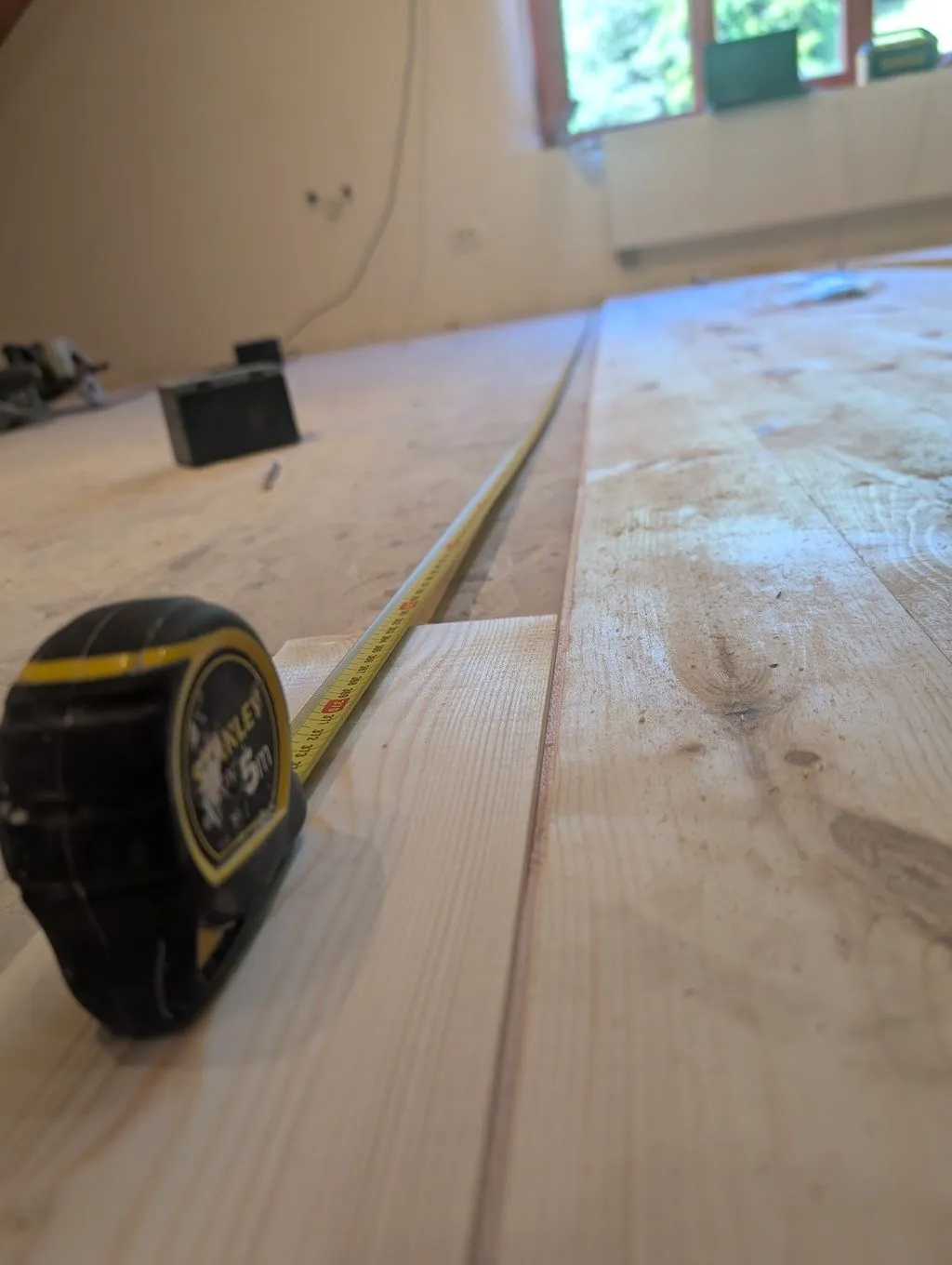 Measuring the length of board needed to complete the current row.