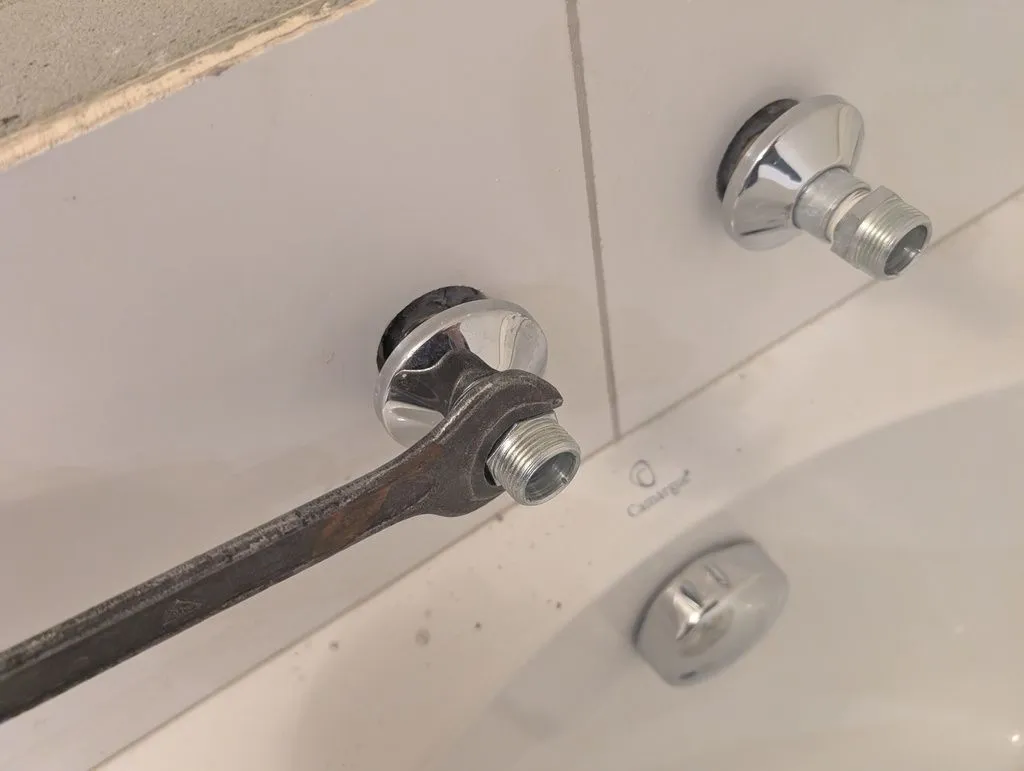 Tightening on the female-to-male fittings for the bathtub faucet.