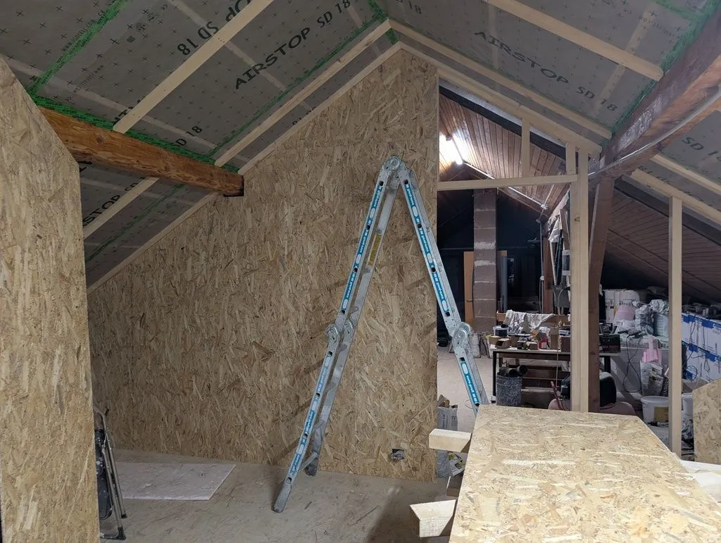 Sheathing of the main partition wall halfway complete.
