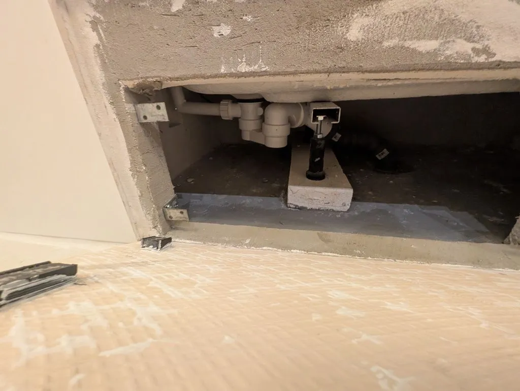 Magnets on the back of the blind tile will attach to these steel angle brackets on the wall.