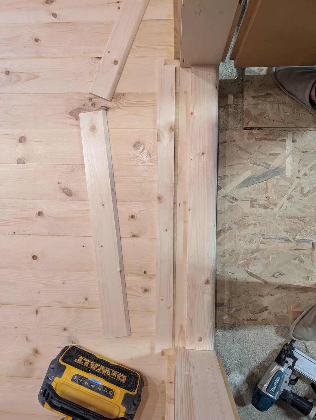 The second piece of the threshold, with ends notched to fit around the door jambs, ready for installation.