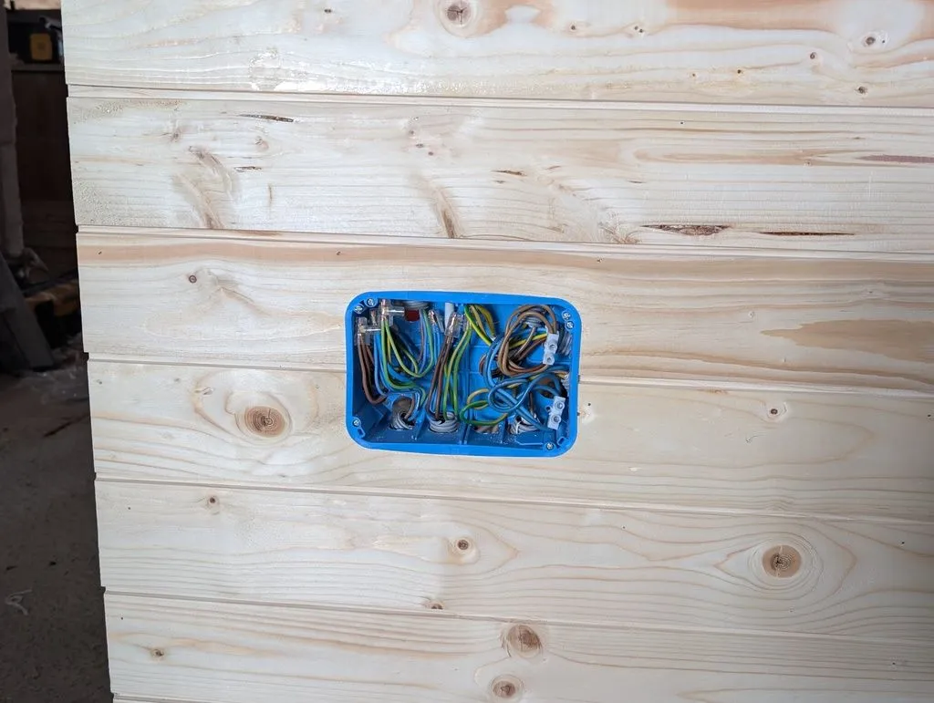 The wired junction box, which serves as a secondary distribution box from the main panel. The circuits from the main panel split off in this box and travel through the attic living space.