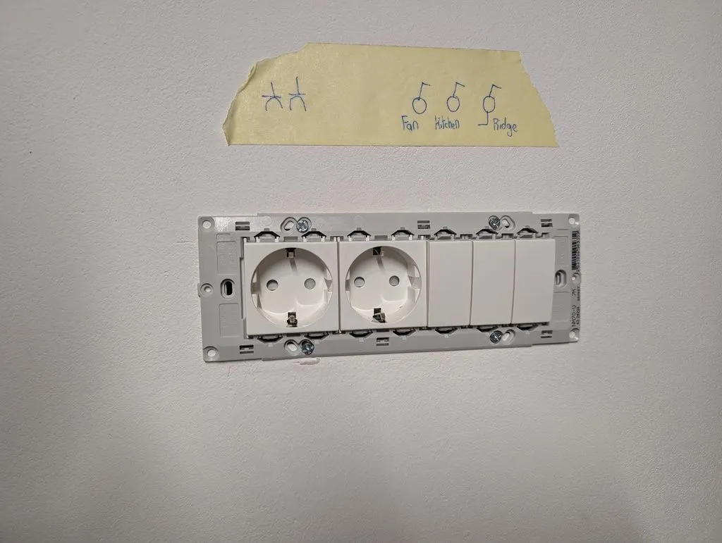 The outlets and switches click into the gray mounting frame with a (in my opinion) delightful modular clip/tab click-in system made by TEM Čatež, a local Slovenian electrical manufacturer. The system is modular, with an outlet taking up the width of two switches.