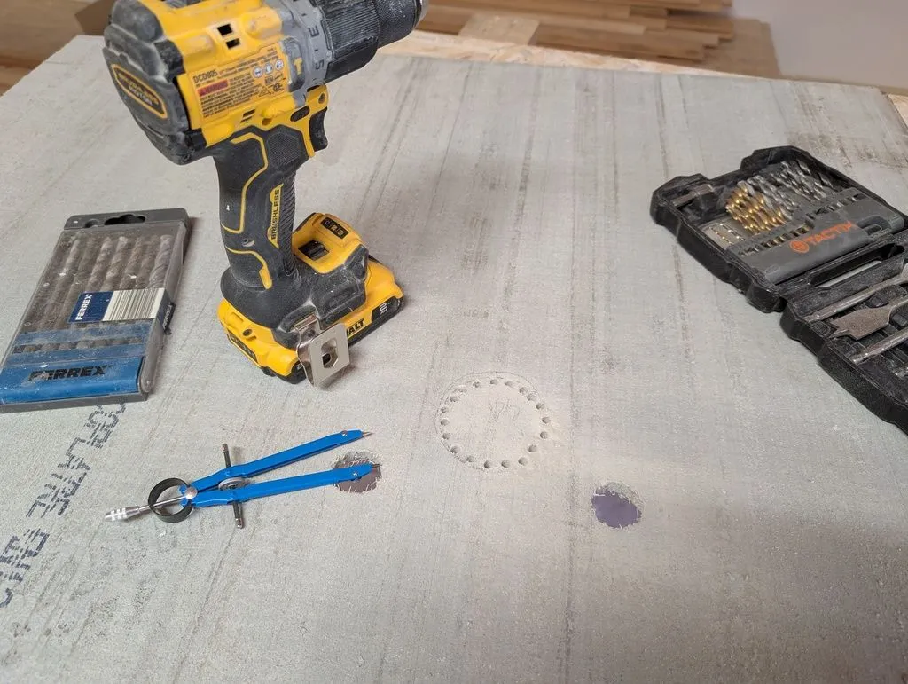 Marking and drilling holes in the cement board to fit over plumbing lines. True to its name, the cement board is difficult to work and will immediatly dull a conventional drywall hole saw. I instead drilled out the circumference of large holes with a masonry bit, then punched out the hole.