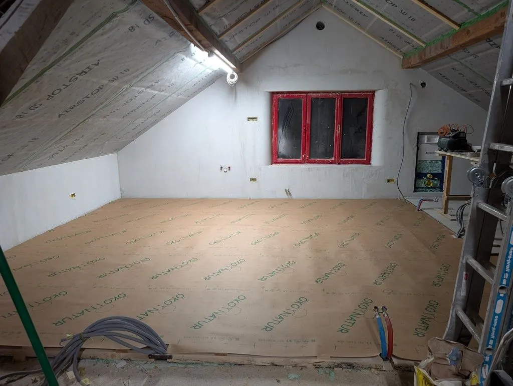The insulated subfloor covered with construction paper, ready for the OSB subfloor.