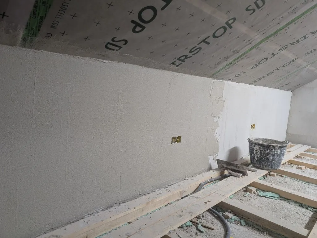 The finish coat progressing along the south wall.