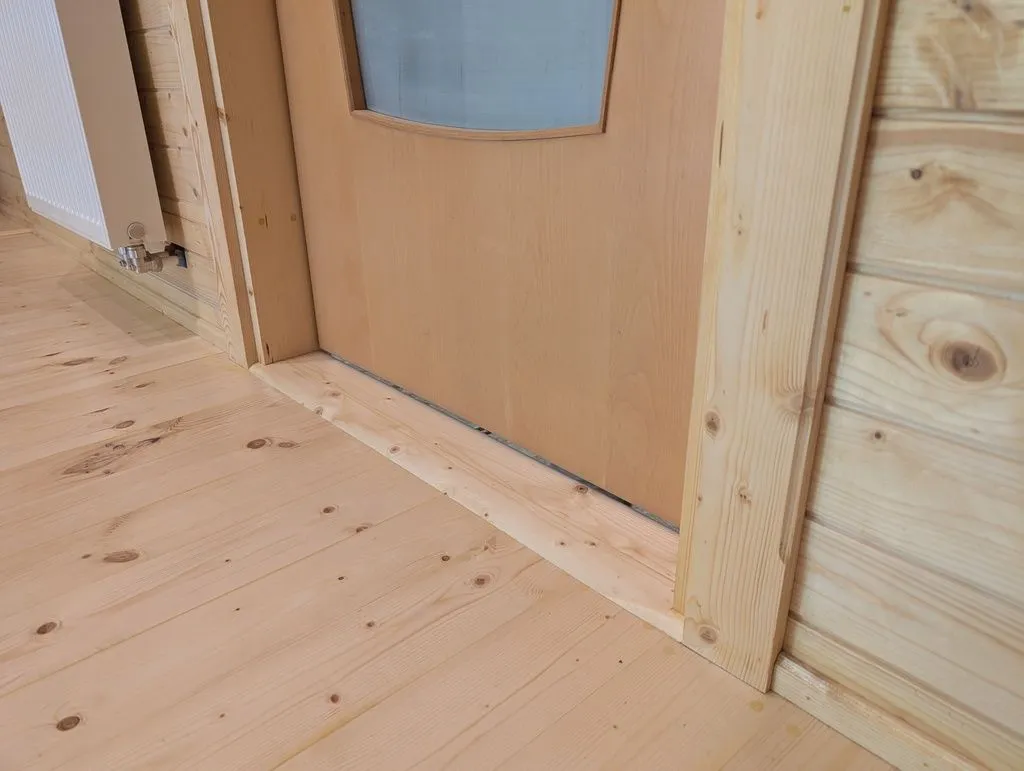 The main entry threshold after filling, sanding, and finishing.