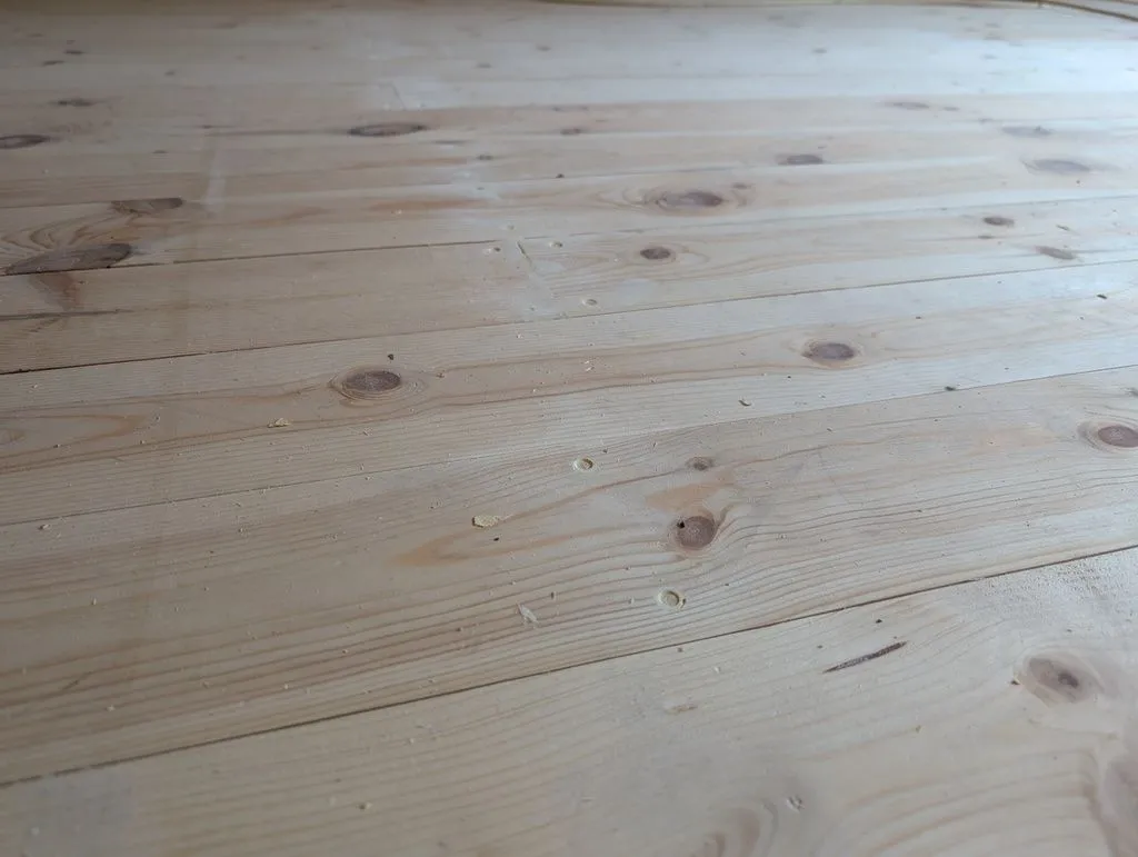 The screw holes after a first application of filler. The filler shrinks slightly, so we applied it in two coats—an initial bulk coat (shown above), followed by a finish coat flush with the surface.