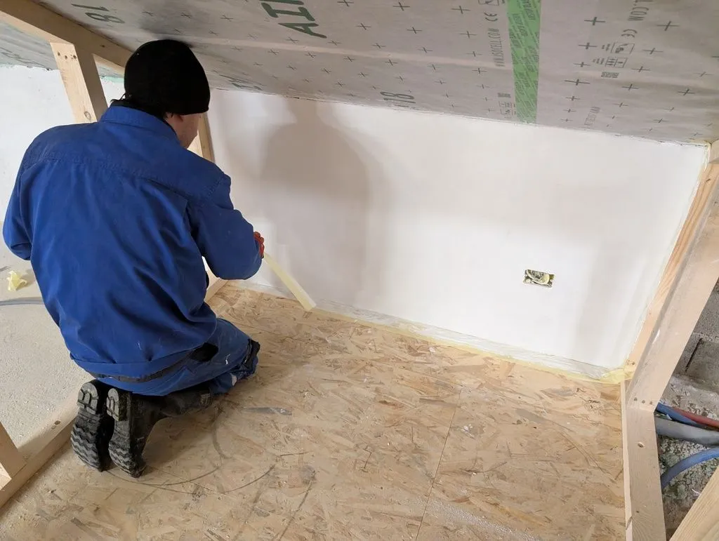 All done! Martin, who helped throughout the painting process, is removing masking tape after we finished painting.