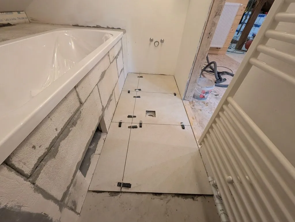 The first phase of the floor tiling complete. We did this in two phases—the long narrow geometry of the bathroom floor makes it difficult to do in a single phase without boxing yourself in.