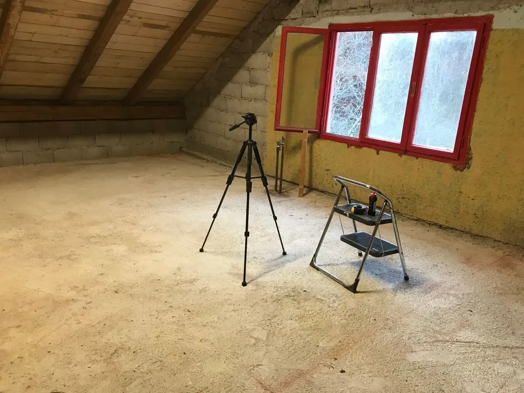 The cleaned floor after finishing the finish ceiling removal. The tripod will later hold a laser level.