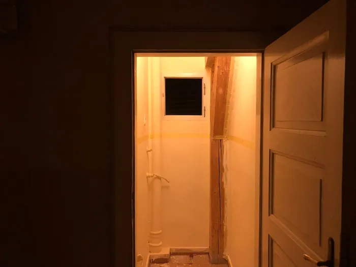 A zoomed-out view of the office with the first coat of paint applied.