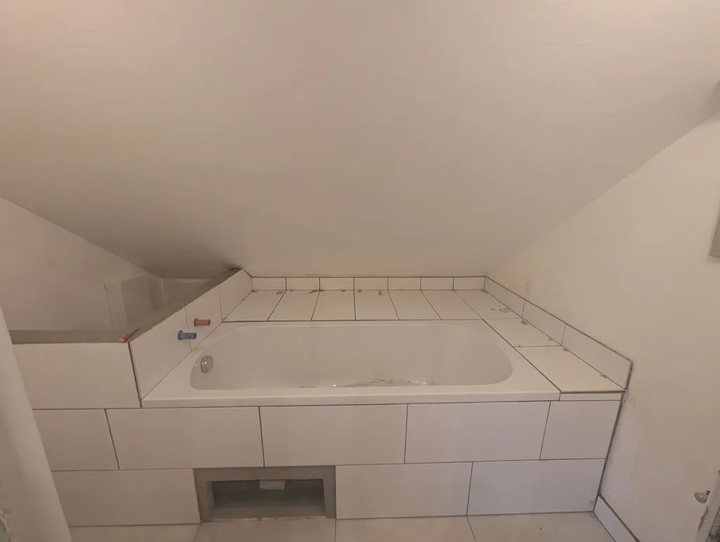 The flat area at the top of the bathtub complete. The hole at the base of the tub is for servicing the bathtub drain, and will be covered by a removable blind tile—more on this below.