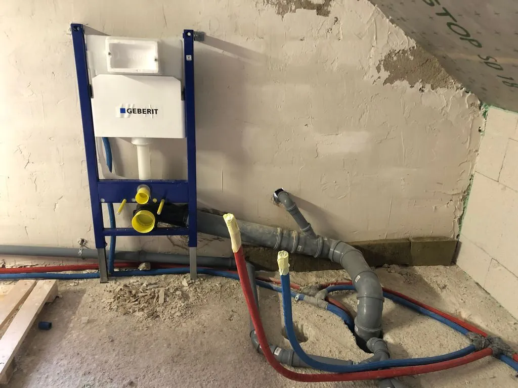 The drain and supply lines for the toilet and bath. The Geberit piece is the substructure that will hold the suspended toilet.