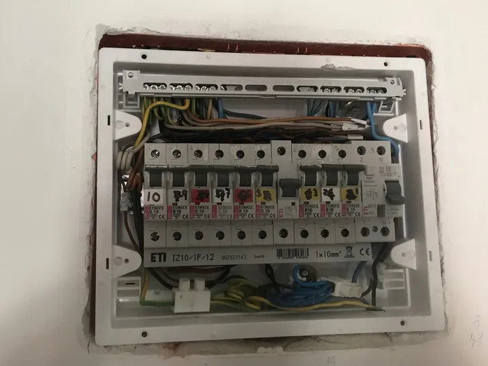The panel after completing the rewiring but before patching surrounding plaster and cleaning up.