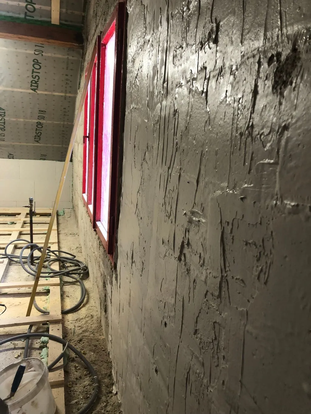 The leveling compound is applied with a trowel—this is the base coat—more coats will follow.